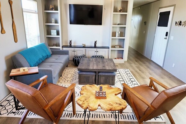 Living space, the sofa lays down into a bed. Extra stool seating under the table