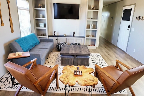 Living space, the sofa lays down into a bed. Extra stool seating under the table