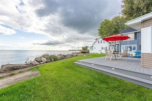 Relax on the deck with uninterrupted views of the water. The perfect spot for morning coffee or sunset drinks by the shore!