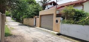 The small gate beside the roller gate is your private entry.