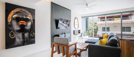 Living room – thoughtfully decorated with artwork, featuring comfortable seating and a dedicated workspace
