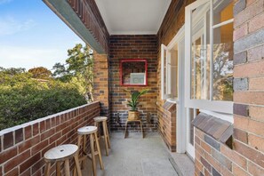 Sip your morning cuppa or unwind with an evening wine on the red-brick balcony, surrounded by lush greenery.