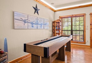 Challenge friends and family to a game of shuffleboard in this cozy, well-lit game room with beautiful wood accents.