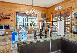 A bright and well-equipped kitchen with a charming farmhouse sink and plenty of counter space for preparing meals.