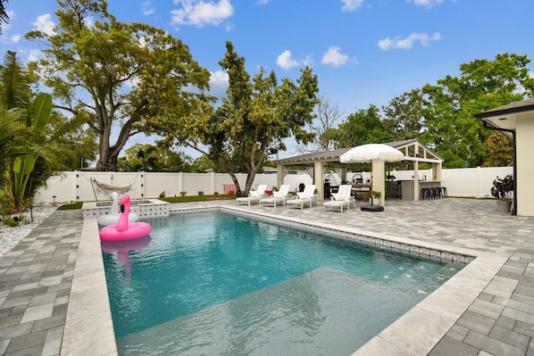 Private pool with lounge chairs & floaties for ultimate relaxation.