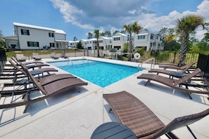 Luxurious poolside retreat with modern homes and tropical landscaping.