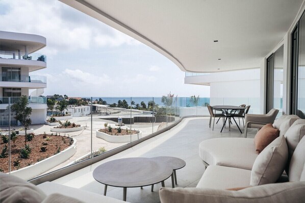 Relax and unwind on this stunning balcony with panoramic ocean views, perfect for enjoying the serenity of coastal living.