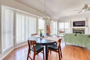 Sunlight streams into this inviting dining area, illuminating a space perfect for gathering and conversation.