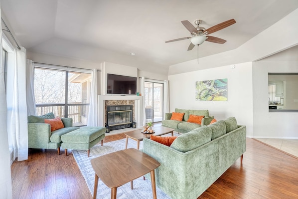 Cozy and stylish living room with modern décor, warm wood flooring, and a fireplace for ultimate comfort.