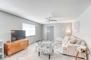 Bright and airy living area featuring a comfortable sofa bed and a flatscreen TV—ideal for relaxing and entertaining
