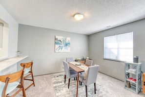 Dining area with seating for four plus a bar counter—providing comfortable space for everyone.