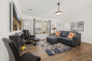 The living room features a Smart TV with all your favorite streaming channels, along with seating.