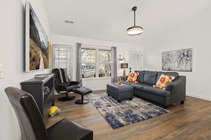 The living room features a Smart TV with all your favorite streaming channels, along with seating.