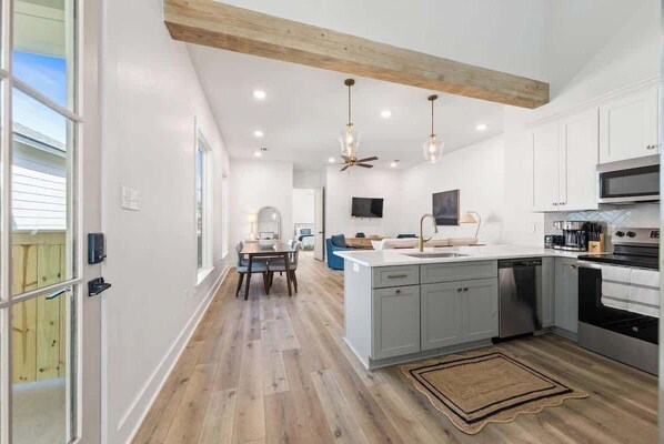 Kitchen, living room, dining room and door to the primary bedroom!