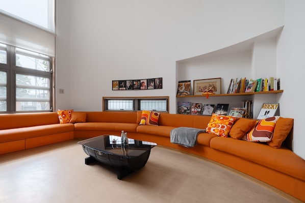 A spacious, light-filled living area where design meets comfort—perfect for families and groups
