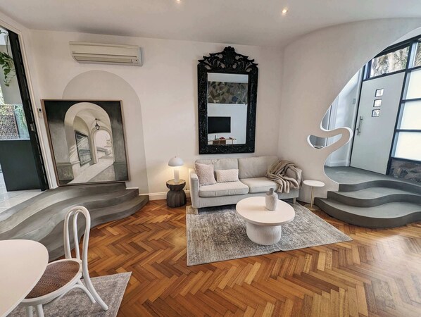Living and dining room with gorgeous art, comfortable furniture & flat screen TV