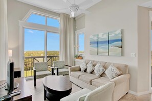 Open concept living area with TV sofa bed and balcony access