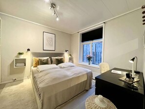 A well-appointed bedroom with a desk for work or relaxation.