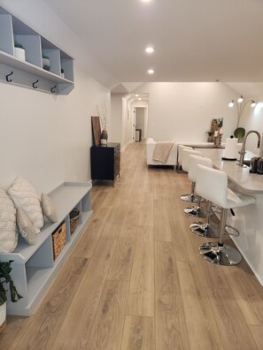 An inviting entrance with new hardwood flooring and soothing spa-like pallette 