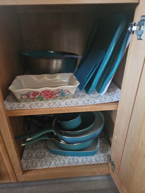 Kitchen cabinets fully stocked w/ cooking supplies, sml appliances and utensils.