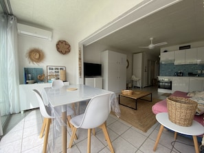Bright living room includes a sitting area, dining area and kitchen