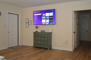 The living room boasts this huge 65" ROKU smart TV.