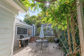 Patio with a gas grill, outdoor shower and dinning table for 8 (coming May 2025)