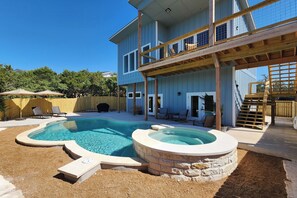 Fenced space surrounding the pool and hot tub