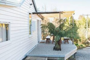 The front deck, outdoor dining area and entryway.