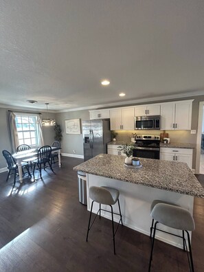 Enjoy the spacious open-concept dining and kitchen area, ideal for meals and gatherings.