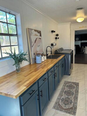 The spacious laundry room is perfect for families or teams, fully equipped with laundry detergent and everything you need to keep your clothes fresh and clean during your stay or between games. 