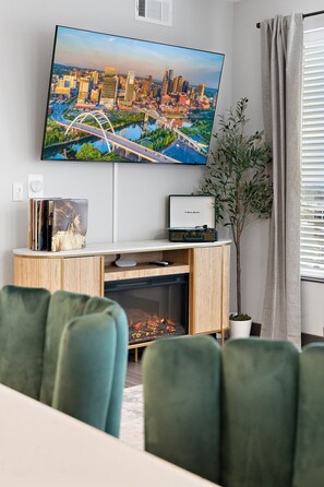Cozy up by the electric fireplace, spin a record, or enjoy a movie night on the smart TV — your perfect chill zone awaits.