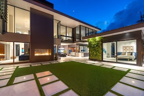 A view of the villa’s architectural brilliance from the backyard—where modern design meets tropical serenity.