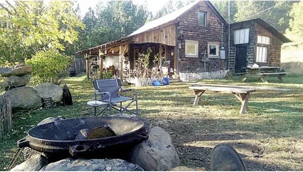 Our wonderful, antiquated cabin with the firepit and large yard. Built 1868.