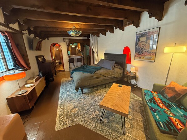 Spacious adobe studio with kiva fireplace, artisan lighting, and cozy charm