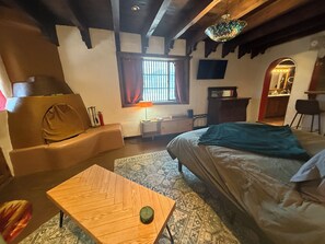 “Adobe charm meets comfort—kiva fireplace, colorful textiles, and cozy vibes in 
