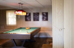 Game area. Pool table, fooseball and bar area. Along with tv and gas fireplace.