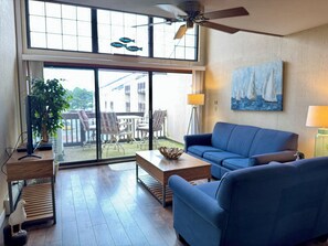 family area with balcony over looking  lake
