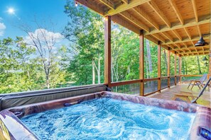 Unwind in the hot tub on the lower level, nestled on the wrap-around balcony.