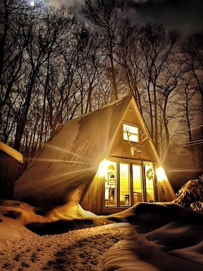 At night, our A-Frame turns into a magical cabin of romance hidden in the enchanted woods
