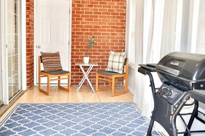 Relax in this magnificent sunroom with private outdoor access for grill!