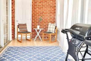Relax in this magnificent sunroom with private outdoor access for grill!