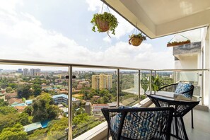 Cozy breakfast nook on the balcony with hanging potted plants