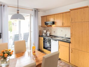 Furniture, Interior Design, Flooring, Wood, Floor, Countertop, Cabinetry, Room, Kitchen, Lighting
