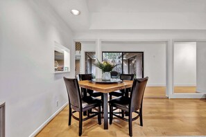 Elegant Dining Experience: Share delicious meals around the stylish dining table while enjoying marsh views through large windows.