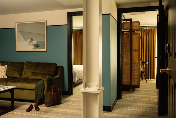 Spacious and stylish suite, where rich textures and deep hues create a cozy yet refined retreat.