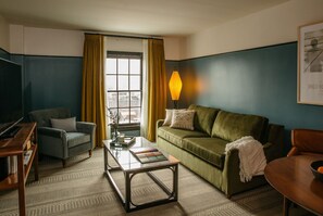Inviting living space, where plush seating, warm lighting, and rich hues create a cozy yet sophisticated retreat.