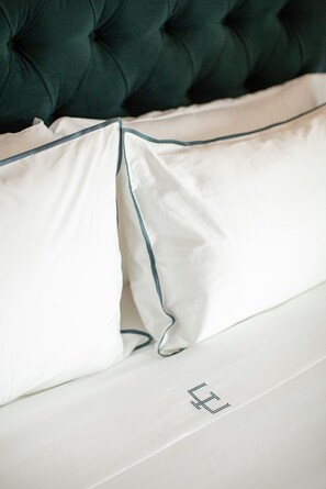 Plush bedding with elegant detailing, ensuring a restful and luxurious night’s sleep.