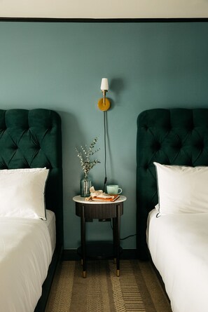 Refined comfort with a bold touch, featuring plush bedding and deep hues for a restful stay.