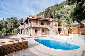 Our propertys building with the communal swimming pool